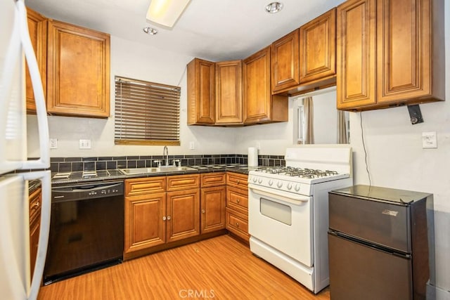 1085 N Arrowhead Ave, San Bernardino, CA 92410 - kitchen with white appliances, dark countertops, brown cabinets, and light wood finished floors