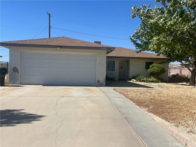 1589 Monte Vista Ave, Rosamond, CA 93560 - ranch-style house featuring stucco siding, concrete driveway, and an attached garage