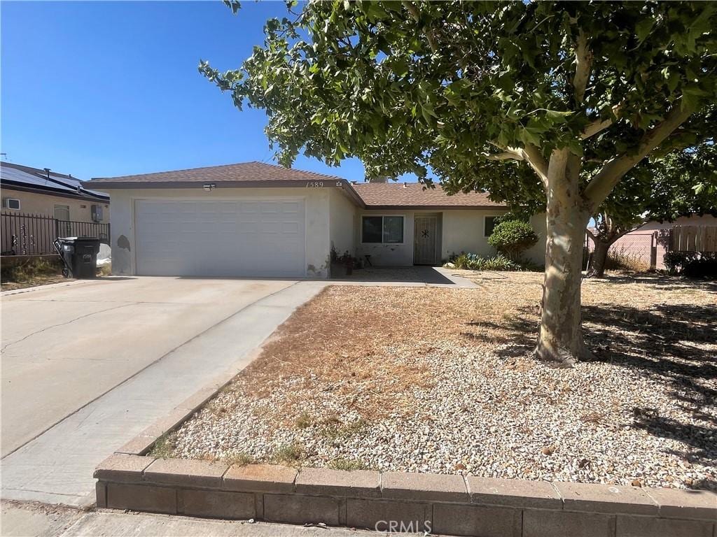 1589 Monte Vista Ave, Rosamond, CA 93560 - ranch-style house featuring an attached garage, stucco siding, and concrete driveway