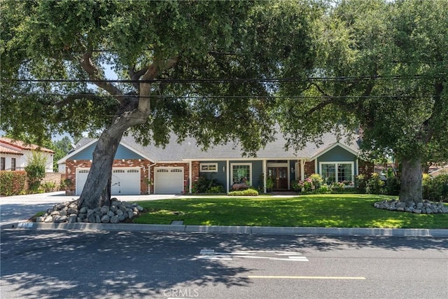 530 Bradbury Rd, Monrovia, CA 91016 - view of front of home featuring a front yard, driveway, an attached garage, and brick siding