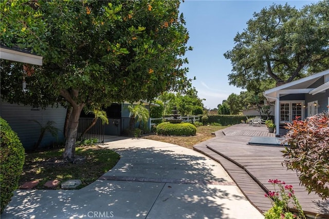 530 Bradbury Rd, Monrovia, CA 91016 - fenced yard featuring a wooden deck, a gate, concrete driveway, and french doors