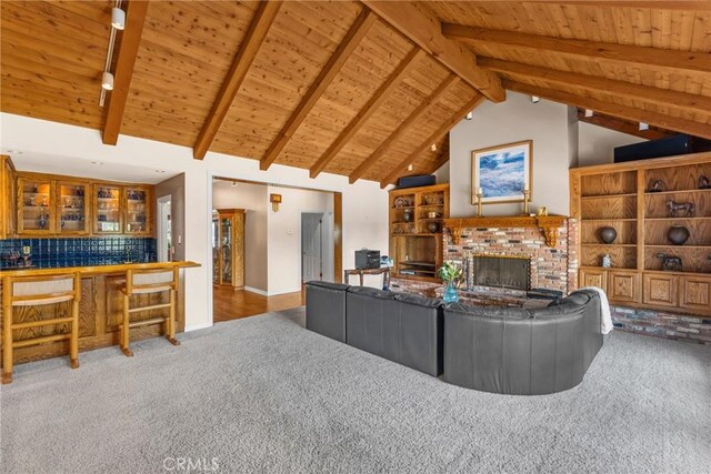 530 Bradbury Rd, Monrovia, CA 91016 - living area featuring carpet, a wooden ceiling with exposed beams, a brick fireplace, bar area, and high vaulted ceiling