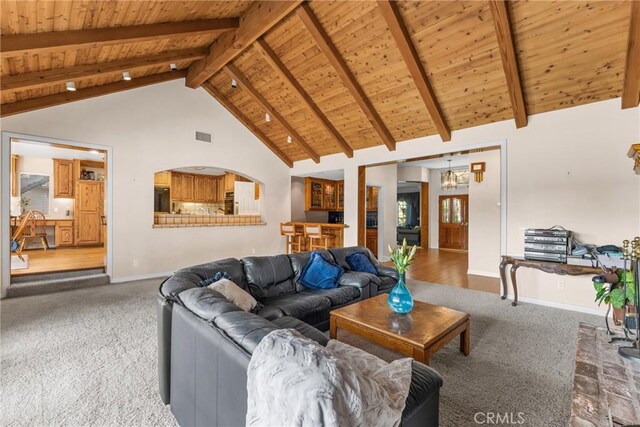 530 Bradbury Rd, Monrovia, CA 91016 - carpeted living area with a wood ceiling with exposed beams, high vaulted ceiling, and a chandelier