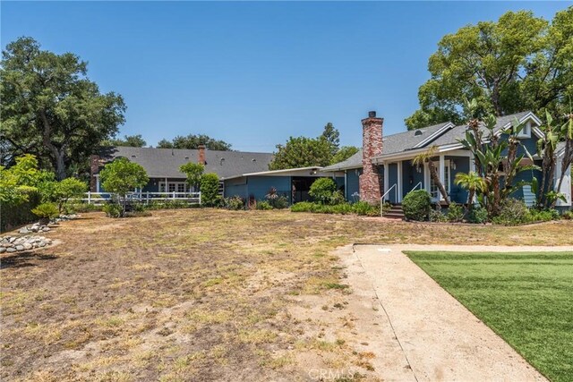 530 Bradbury Rd, Monrovia, CA 91016 - view of front facade with a front yard and a chimney