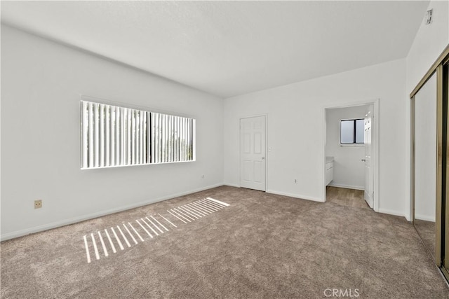 4706 Sepulveda Blvd, Sherman Oaks, CA 91403 - unfurnished bedroom with carpet flooring, multiple windows, ensuite bath, and a closet