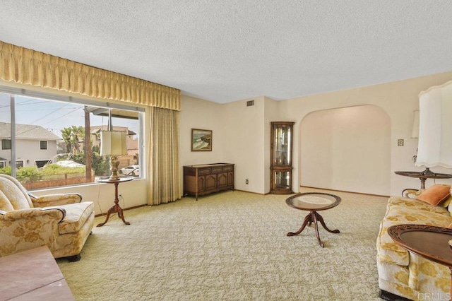 3448 Goldfinch St, San Diego, CA 92103 - living area with arched walkways, a textured ceiling, and carpet floors