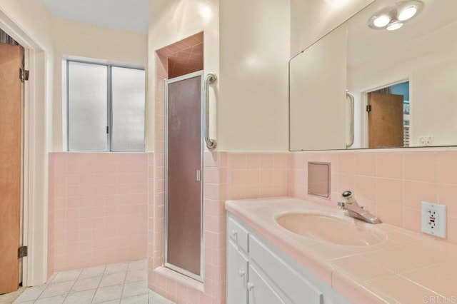 3448 Goldfinch St, San Diego, CA 92103 - bathroom with a shower stall, vanity, tile patterned flooring, and tile walls