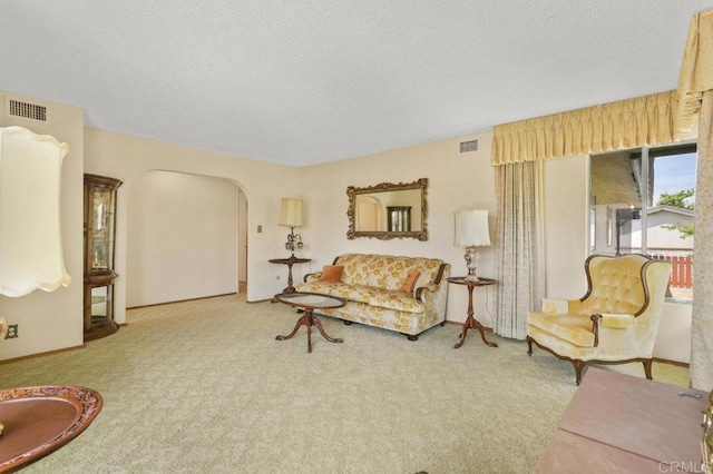 3448 Goldfinch St, San Diego, CA 92103 - carpeted living room featuring arched walkways and a textured ceiling