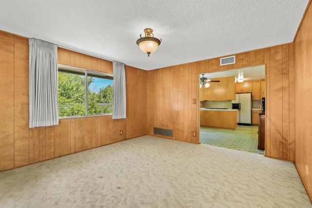 3448 Goldfinch St, San Diego, CA 92103 - unfurnished room featuring wooden walls, a textured ceiling, and carpet flooring