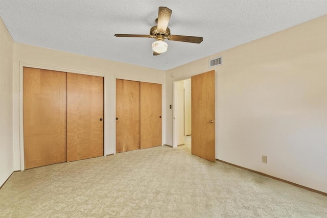 3448 Goldfinch St, San Diego, CA 92103 - unfurnished bedroom with two closets, carpet flooring, a textured ceiling, and a ceiling fan