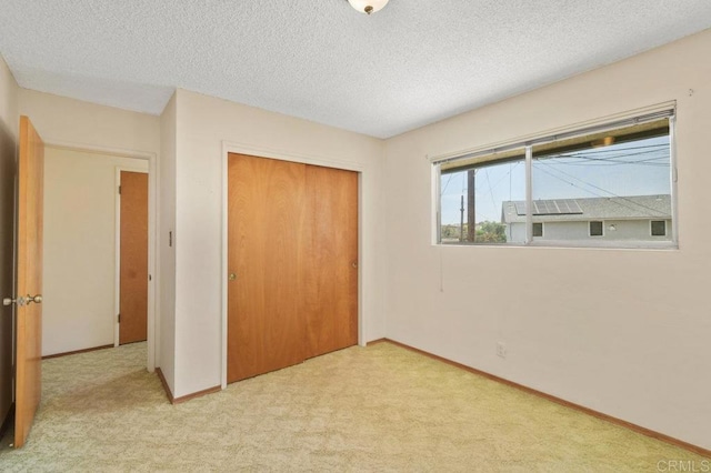 3448 Goldfinch St, San Diego, CA 92103 - unfurnished bedroom with a closet, light colored carpet, and a textured ceiling