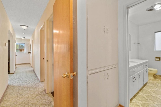 3448 Goldfinch St, San Diego, CA 92103 - corridor with light carpet and arched walkways