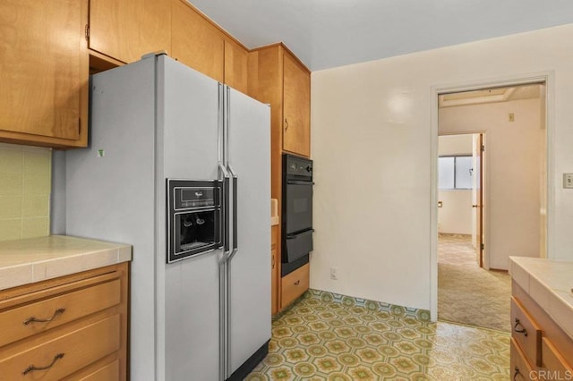 3448 Goldfinch St, San Diego, CA 92103 - kitchen featuring white refrigerator with ice dispenser, oven, tile countertops, a warming drawer, and backsplash