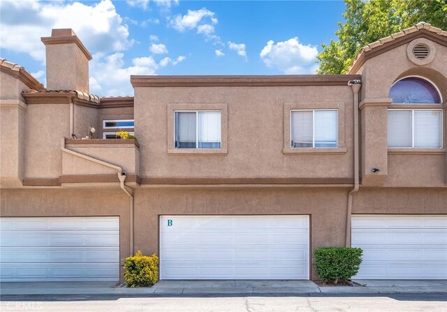 14711 Moon Crest Ln Unit B, Chino Hills, CA 91709 - rear view of house featuring stucco siding and an attached garage