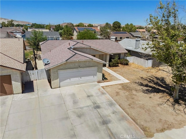 2021 Buckwheat Ave, Rosamond, CA 93560 - view of front of property with a residential view, driveway, a garage, stucco siding, and a shingled roof