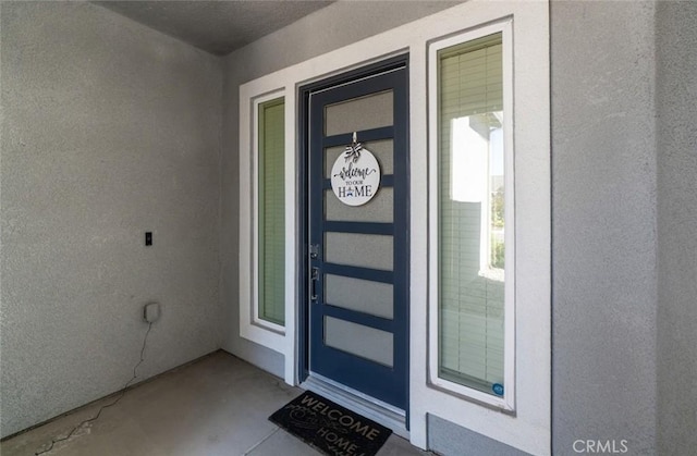 825 Spring St W, Madera, CA 93636 - doorway to property with stucco siding