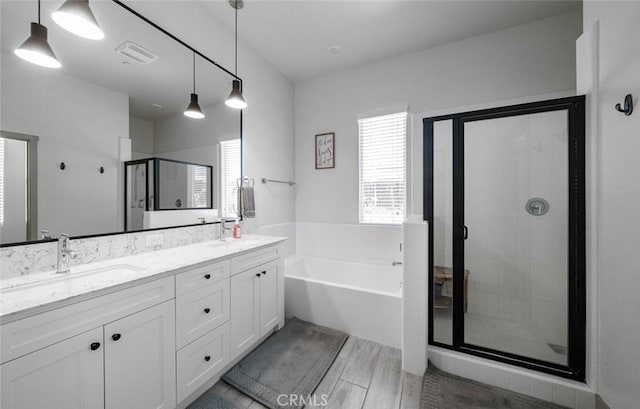 825 Spring St W, Madera, CA 93636 - full bath featuring a bath, a shower stall, double vanity, and wood finished floors
