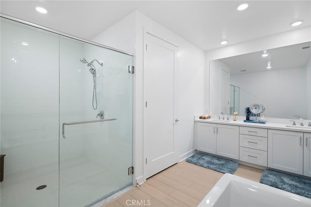 3100 Rivington, Irvine, CA 92612 - bathroom featuring a stall shower, double vanity, recessed lighting, wood finished floors, and a bathtub