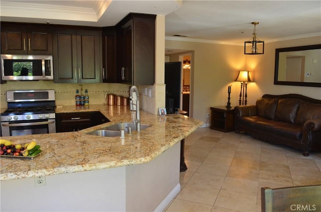 25592 Aragon Way, Yorba Linda, CA 92887 - kitchen featuring stainless steel appliances, light stone countertops, crown molding, dark brown cabinets, and backsplash