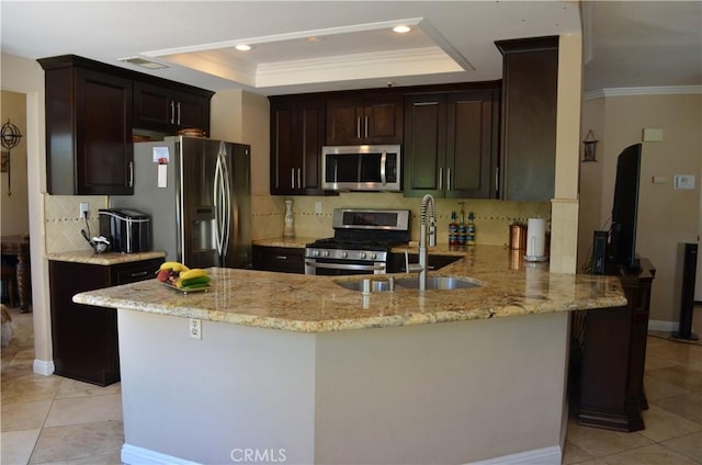25592 Aragon Way, Yorba Linda, CA 92887 - kitchen featuring stainless steel appliances, a tray ceiling, light tile patterned flooring, light stone countertops, and ornamental molding