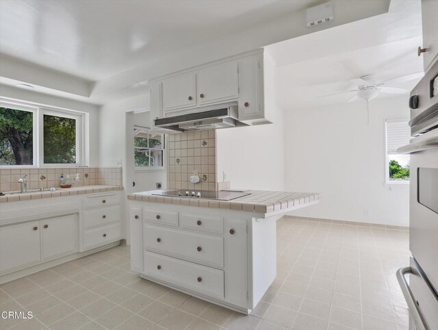 3914 Alta Vista Dr, La Canada Flintridge, CA 91011 - kitchen featuring under cabinet range hood, tile countertops, black electric stovetop, tasteful backsplash, and ceiling fan