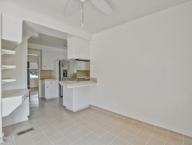 3914 Alta Vista Dr, La Canada Flintridge, CA 91011 - kitchen featuring white cabinets, stainless steel fridge with ice dispenser, backsplash, light countertops, and light tile patterned floors