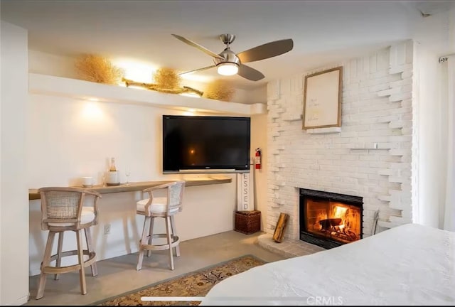 70138 Sullivan Rd Unit 29, Palms, CA 92277 - bedroom featuring a brick fireplace and finished concrete floors