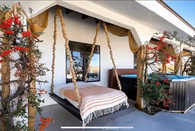 70138 Sullivan Rd Unit 29, Palms, CA 92277 - view of property exterior featuring a hot tub and stucco siding