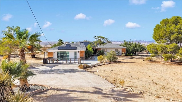 70138 Sullivan Rd Unit 29, Palms, CA 92277 - view of front of property with roof mounted solar panels, stucco siding, and driveway