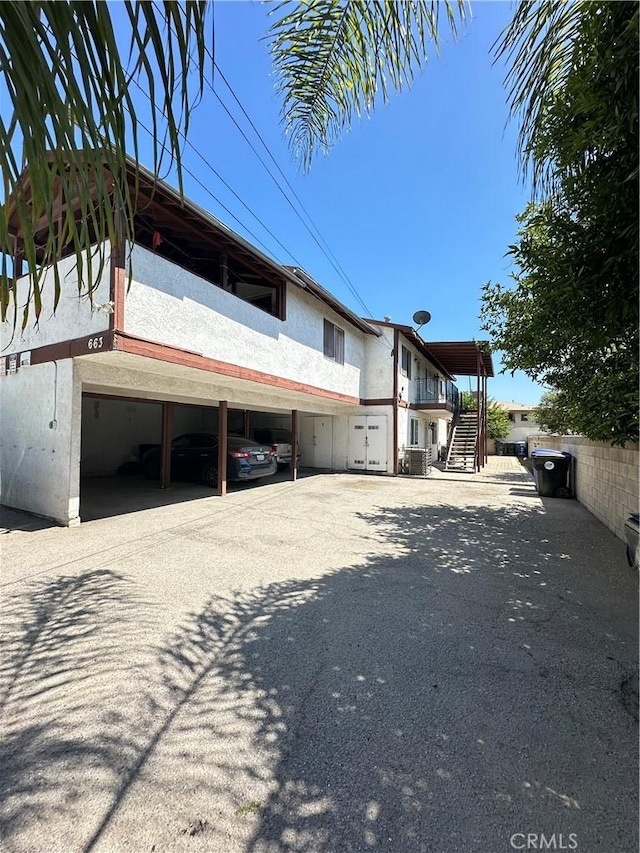 663 W 14th St, San Bernardino, CA 92405 - view of home's exterior with stairway and a central air condition unit