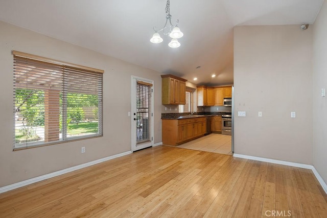 117 S Machala Pl, Rialto, CA 92376 - kitchen featuring appliances with stainless steel finishes, dark countertops, light wood-style floors, a chandelier, and recessed lighting