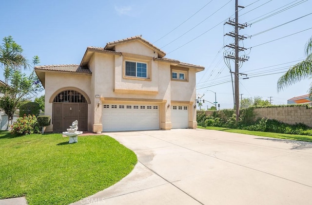 117 S Machala Pl, Rialto, CA 92376 - mediterranean / spanish-style home featuring a garage, concrete driveway, stucco siding, and a tiled roof