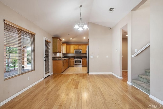 117 S Machala Pl, Rialto, CA 92376 - kitchen with stainless steel appliances, dark countertops, light wood finished floors, a chandelier, and recessed lighting