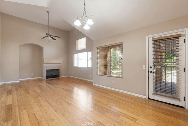 117 S Machala Pl, Rialto, CA 92376 - unfurnished living room with a fireplace, light wood-style flooring, ceiling fan, high vaulted ceiling, and arched walkways