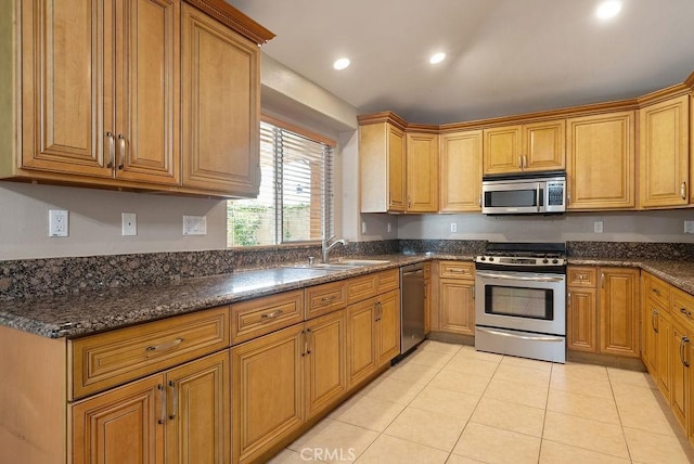 117 S Machala Pl, Rialto, CA 92376 - kitchen with appliances with stainless steel finishes, light tile patterned floors, recessed lighting, brown cabinetry, and dark stone counters