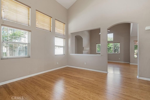 117 S Machala Pl, Rialto, CA 92376 - unfurnished room with light wood-style floors, high vaulted ceiling, and arched walkways