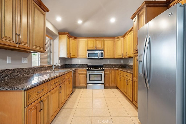 117 S Machala Pl, Rialto, CA 92376 - kitchen with appliances with stainless steel finishes, dark stone countertops, light tile patterned floors, brown cabinets, and recessed lighting