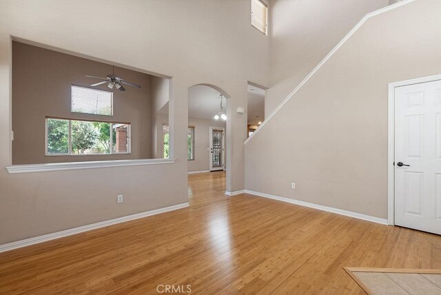 117 S Machala Pl, Rialto, CA 92376 - entryway featuring arched walkways, a ceiling fan, wood finished floors, and a high ceiling