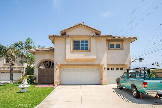 117 S Machala Pl, Rialto, CA 92376 - view of front of home with driveway, stucco siding, a garage, a tile roof, and a front lawn