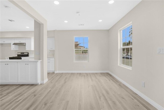 339 E 8th St, Azusa, CA 91702 - unfurnished living room with light wood-style floors, healthy amount of natural light, and recessed lighting