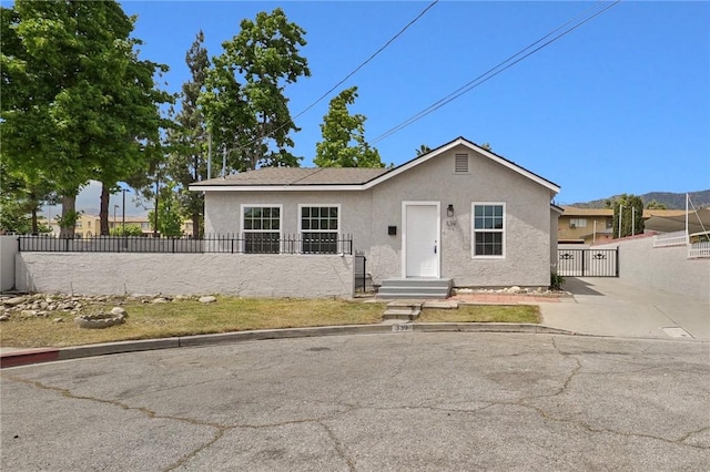 339 E 8th St, Azusa, CA 91702 - view of front of home with stucco siding and a gate
