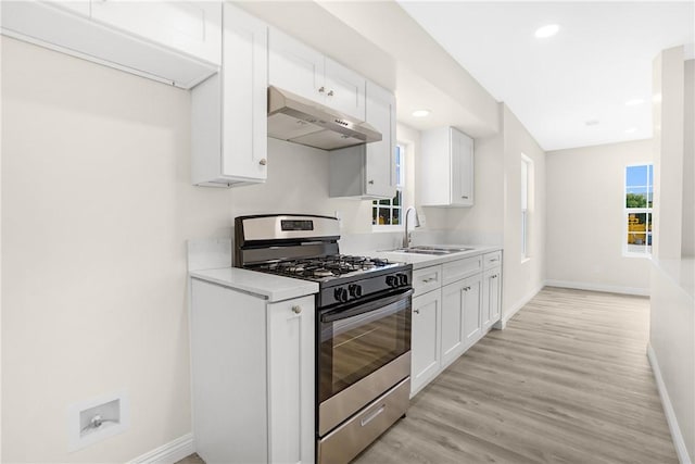 339 E 8th St, Azusa, CA 91702 - kitchen with stainless steel gas range, under cabinet range hood, light countertops, plenty of natural light, and recessed lighting