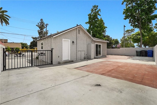 339 E 8th St, Azusa, CA 91702 - back of house featuring stucco siding, a patio, and a gate