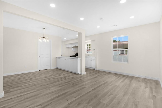 339 E 8th St, Azusa, CA 91702 - unfurnished living room featuring light wood-type flooring, recessed lighting, and a chandelier