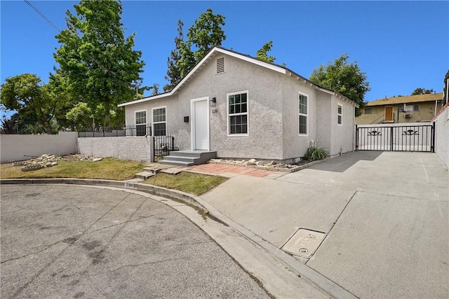339 E 8th St, Azusa, CA 91702 - view of front of home featuring stucco siding and a gate