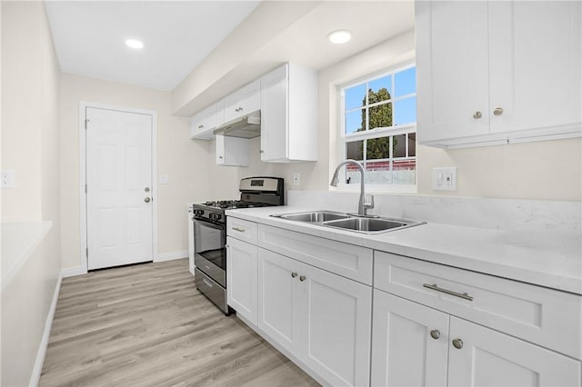 339 E 8th St, Azusa, CA 91702 - kitchen featuring gas stove, under cabinet range hood, white cabinets, light countertops, and recessed lighting
