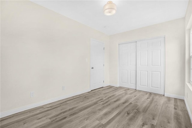 339 E 8th St, Azusa, CA 91702 - unfurnished bedroom with wood finished floors and a closet