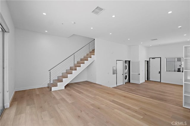 957 Figueroa Unit 318, Los Angeles, CA 90012 - unfurnished living room featuring stairway, light wood finished floors, and recessed lighting