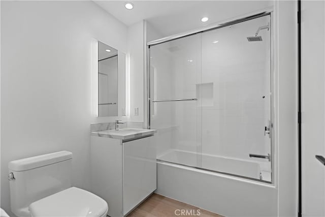 957 Figueroa Unit 318, Los Angeles, CA 90012 - bathroom featuring enclosed tub / shower combo, vanity, recessed lighting, and wood finished floors
