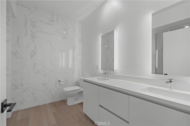 957 Figueroa Unit 318, Los Angeles, CA 90012 - bathroom featuring double vanity and wood finished floors